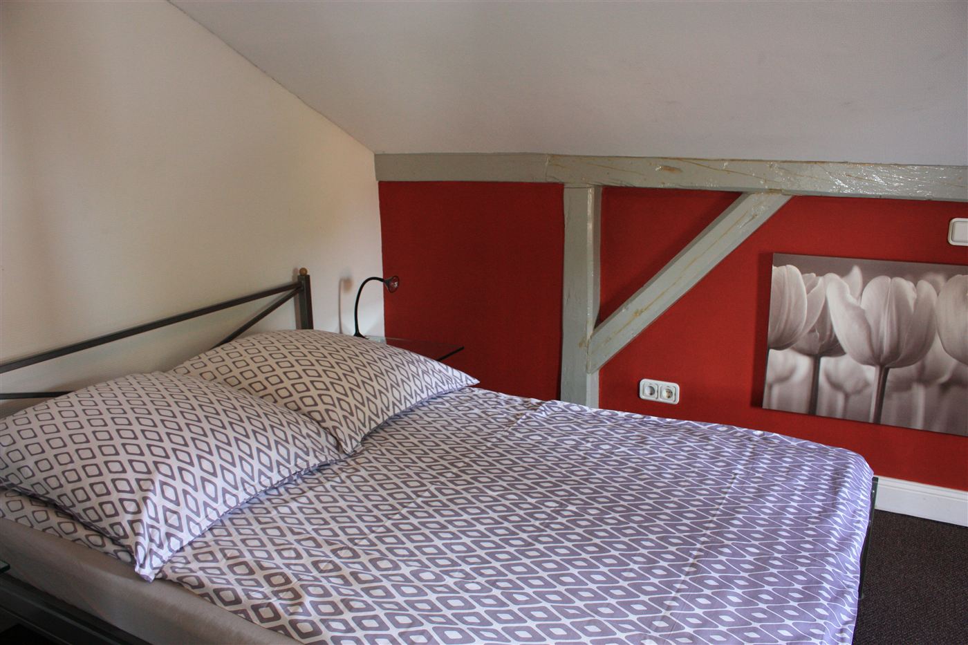 Schlafzimmer mit Doppelbett unter der Dachschräge